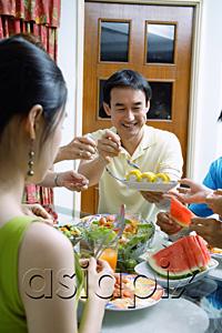 AsiaPix - Father passing food to family members