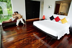 AsiaPix - Couple in bedroom, sitting on daybed