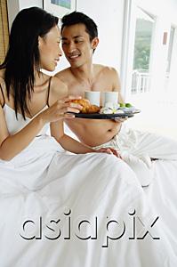 AsiaPix - Couple having breakfast in bed, man holding tray