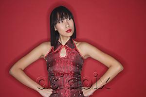 AsiaPix - Woman against red background, dressed in cheongsam, hands on hips