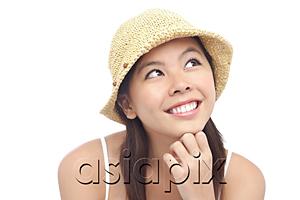 AsiaPix - Young woman wearing hat, looking away, hand on chin