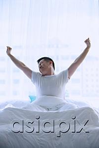 AsiaPix - Man in bed, stretching