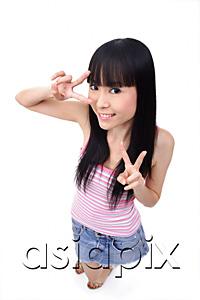 AsiaPix - Young woman making peace sign, smiling
