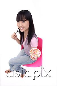 AsiaPix - Young woman sitting, holding bowl of ice cream