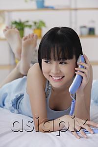 AsiaPix - Young woman using telephone