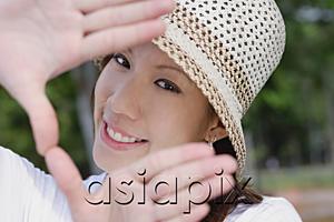 AsiaPix - Young woman wearing hat, making finger frame