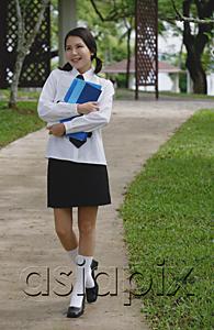 AsiaPix - Young woman in school uniform, walking on path