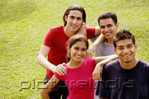 PictureIndia - Young adults standing together, looking at camera, smiling