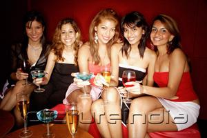 PictureIndia - Women sitting side by side, smiling at camera