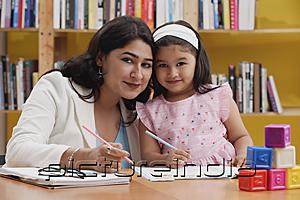 PictureIndia - Woman and girl with books, looking at camera
