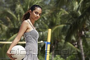 PictureIndia - young woman holding volleyball at the beach