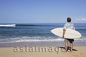 Asia Images Group - man holding surf board on beach
