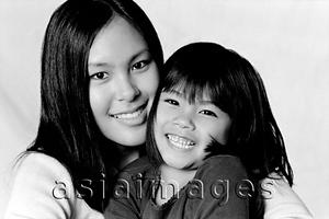 Asia Images Group - Young woman hugging young girl