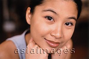 Asia Images Group - Young woman with hands on chin, smiling.