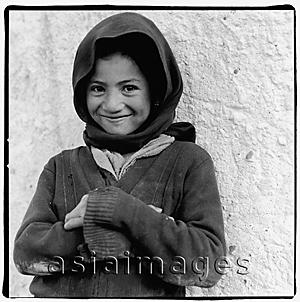 Asia Images Group - India, Ladakh, Portrait of young girl arms crossed, smiling.