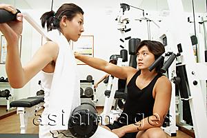 Asia Images Group - Couple working out in gym, weight training