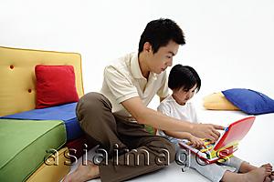 Asia Images Group - Father and daughter looking at childrens laptop
