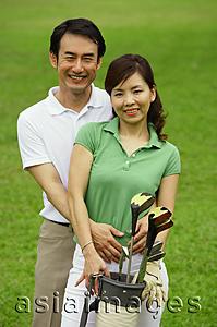 Asia Images Group - Couple standing side by side, looking at camera