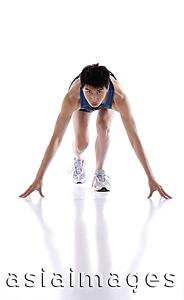 Asia Images Group - Young man bending over in runner's starting position