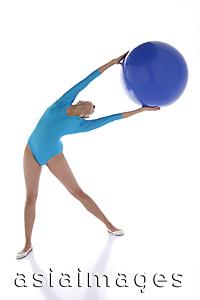 Asia Images Group - Gymnast exercising with fitness ball