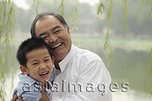 Asia Images Group - Grandfather and young boy laughing together