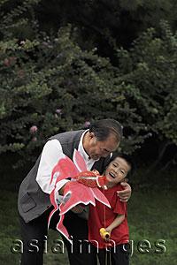 Asia Images Group - Grandfather and grandson playing with kite