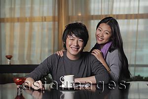 Asia Images Group - Young couple at cafe smiling