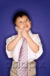 AsiaPix - Boy wearing oversized tie, using mobile phone