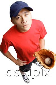 AsiaPix - Young man holding baseball glove and ball, hand on hip