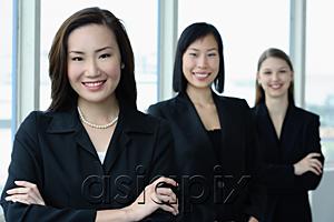 AsiaPix - Businesswomen in a row, smiling at camera