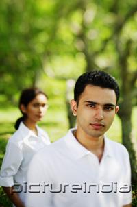 PictureIndia - Man looking at camera, woman in the background